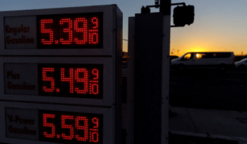 Traffic travels past a sign displaying current gas prices in San Diego, California, U.S., February 28, 2022.